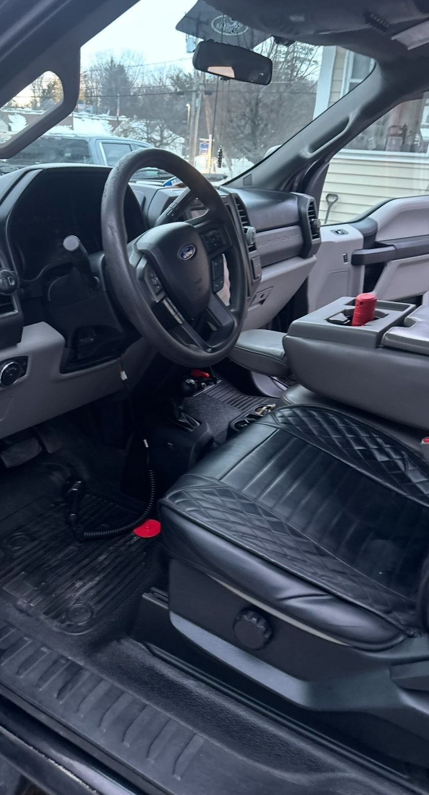 Black leather seats after restoration in a truck interior