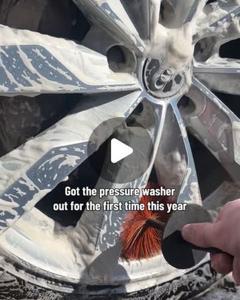 Wheel being cleaned with foam and a brush
